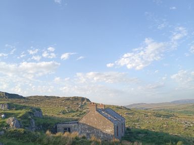 An abandoned building on a hillside with clouds in the sky at Sliabh League Mountain Lodge TEILEANN near Kilcar, County Donegal