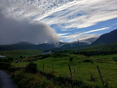 A view of mountains and clouds with a road at Sliabh League Mountain Lodge in TEILEANN near Kilcar, County Donegal