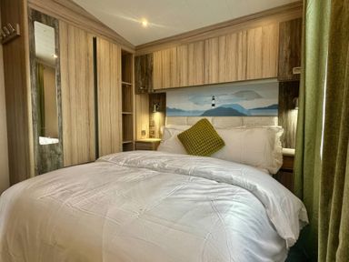 A bedroom with a bed and wardrobes at 101 Bay View in Ayr