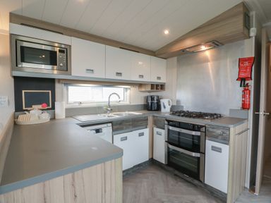 A kitchen with various appliances and cabinetry at 101 Bay View in Ayr