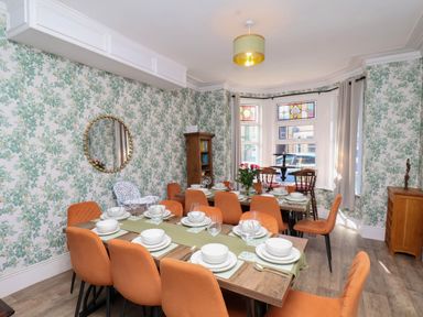 A dining room with a table set for meals at Lansdowne Grange in Bridlington