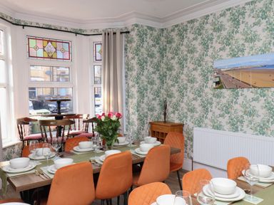 A dining room with a table set for dinner at Lansdowne Grange in Bridlington