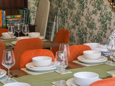 A dining room with table settings and books at Lansdowne Grange in Bridlington