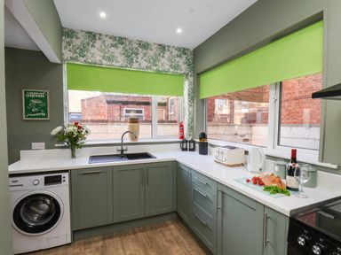 A kitchen with a sink and appliances at Lansdowne Grange in Bridlington