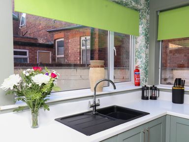 A kitchen with a sink and a flower vase at Lansdowne Grange in Bridlington