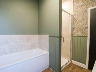 A bathroom with a bathtub and shower at Lansdowne Grange in Bridlington