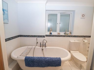 A bathroom with a bathtub and toilet at 2 Inglewood Apartments in Dartmouth