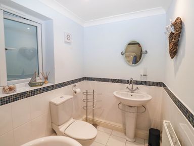 A bathroom containing a toilet, sink, and towel rail at 2 Inglewood Apartments in Dartmouth