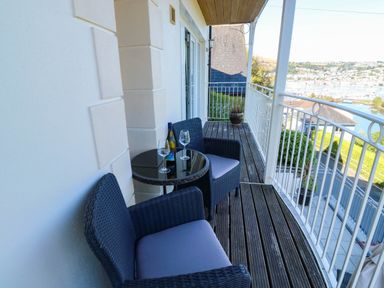 A balcony with chairs and a table at 2 Inglewood Apartments in Dartmouth