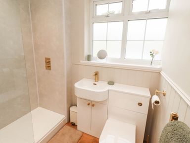 A bathroom with a shower and sink at Hedley Dene Cottage in Longhorsley