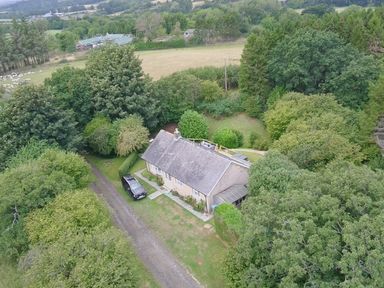 An aerial view of a house surrounded by trees at Hedley Dene Cottage in Longhorsley
