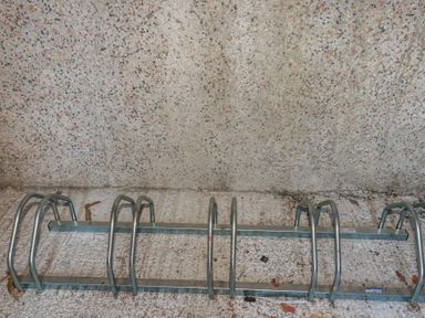 A bicycle rack mounted against a wall at Newseal House