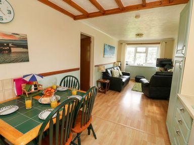 A dining room with a table set for breakfast at Cottage 28 in Brixham