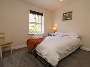 A bedroom with a bed and bedside table at Manning's View Barnstaple