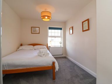 A bedroom with a bed and window at Manning's View in Barnstaple
