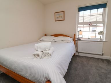 A bedroom with a bed and towels on the bed at Manning's View in Barnstaple