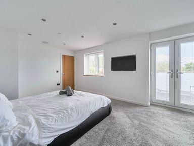 A bedroom with a bed and television at Abergele