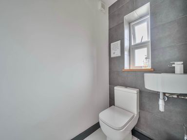 A bathroom with a toilet and sink at The Old Barn in Abergele