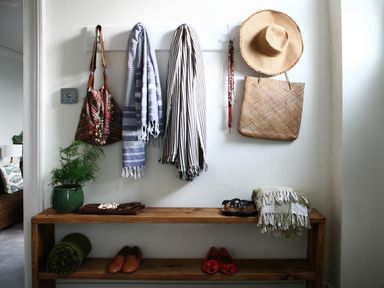 An entryway with coats and a hat on hooks and shoes on a bench at Beautiful 6Bed Sleeps 12 Stunning Views in Lynton