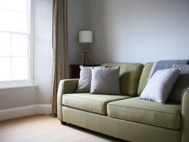 A living room with a sofa and lamp at Beautiful 6Bed Sleeps 12 Stunning Views in Lynton