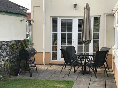 An outdoor seating area with a table and chairs at Build your memories hot tub garden sleeps 14 in Nottage