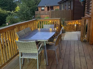 An outdoor dining area with a table and chairs at Blairgowrie Luxury 3 Bed Lodge with Hot Tub in Blairgowrie