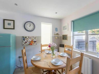 A dining room with a table and chairs at 2 Bedrooms overlooking Little Petherick Creek Little Petherick