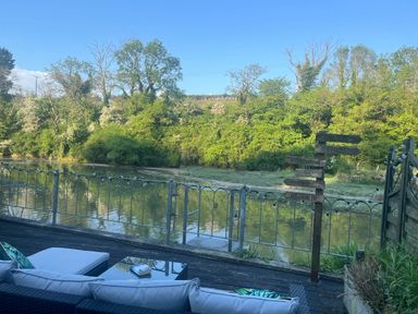 An outdoor area with a river and seating at 2 Bedrooms overlooking Little Petherick Creek in Little Petherick
