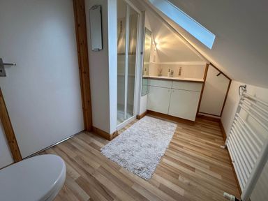 A bathroom with a sink, shower, and toilet at House Sleeps 8 Close to Beach Free parking, Mullion