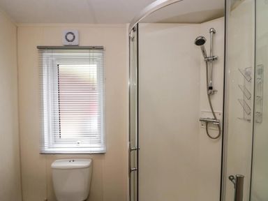 A bathroom with a toilet and shower at Lakeland Lodge 3Bed 2 Bath Private Patio in Carnforth