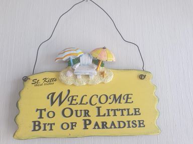 A decorative sign with welcome message at Seaside Lodge Retreat in Eyemouth