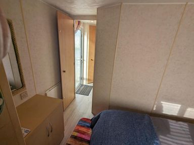 A bedroom with a bed and a door leading outside at Sandy Paws Dog Friendly Anderby Creek