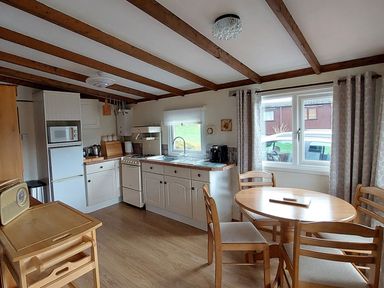 A kitchen with a table and chairs at The Old Barn in Builth Wells