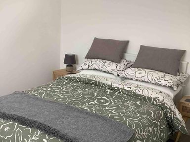 A bedroom with a bed and lamp at 1Bed Coastal Retreat Sleeps 2 Parking Wifi in Bude
