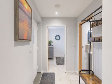 A hallway with a coat rack and a picture frame at 1Bed Coastal Retreat Sleeps 2 Parking Wifi Bude