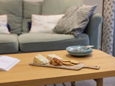 A living room with cheese and grapes on a table at 1Bed Coastal Retreat Sleeps 2 Parking Wifi in Bude