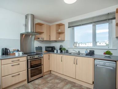 A kitchen with appliances and utensils at Spacious 3 Bed House Sleeps 6 Parking Wifi in Newquay