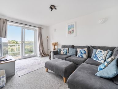 A living room with a sofa and television at Spacious 3 Bed House Sleeps 6 Parking Wifi Newquay