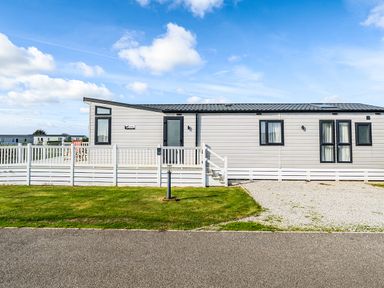 A house with a white fence and grass at 2Br Lodge Pool Fireplace PetsOK Parking in Goonhavern