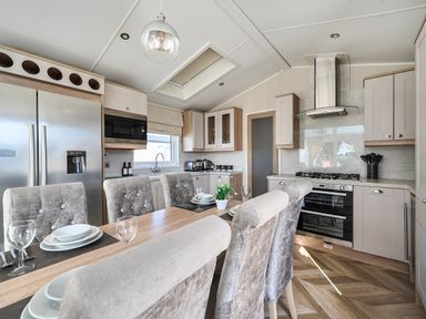 A kitchen with appliances and dining area at 2Br Lodge Pool Fireplace PetsOK Parking Goonhavern