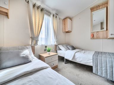 A bedroom with two beds and a bedside table at 2Br Lodge Pool Fireplace PetsOK Parking Goonhavern