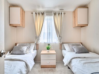 A bedroom with two beds and a plant on a table at 2Br Lodge Pool Fireplace PetsOK Parking Goonhavern
