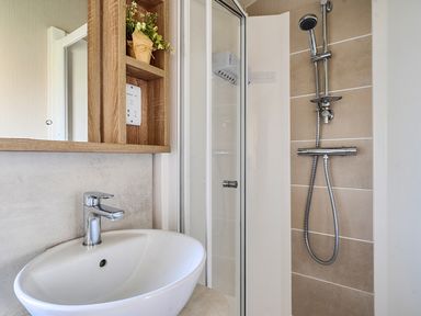 A bathroom with a shower and sink at 2Br Lodge Pool Fireplace PetsOK Parking in Goonhavern