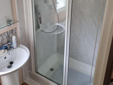 A bathroom with a shower and sink at Chalet Sleeps 6 swimming pool Thorness Bay