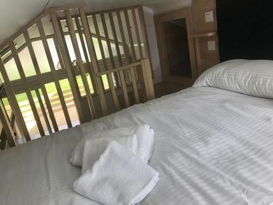 A bedroom with a bed and towels at Selfcatering Lodge Inverness Sleeps 4 Inverness