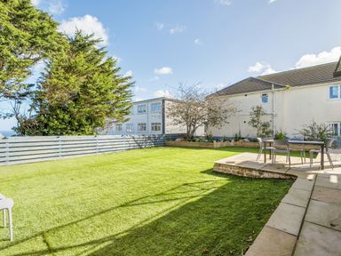 A garden with grass and outdoor seating at 1 Bedroom Apartment Sleeps 2 Pets Welcome in Carbis Bay