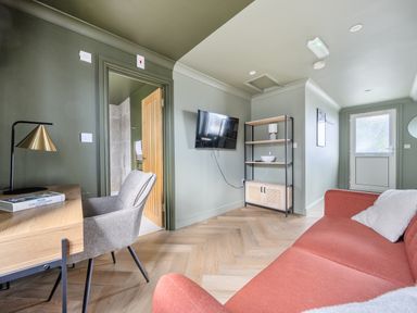 A living room with a sofa and television in 1 Bedroom Apartment Sleeps 2 Pets Welcome in Carbis Bay