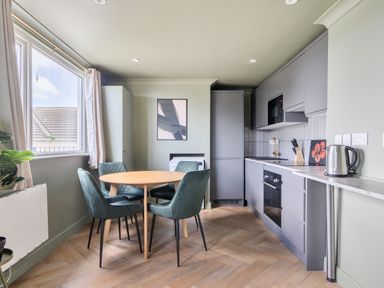A kitchen with a table and chairs at 1 Bedroom Apartment Sleeps 2 Pets Welcome in Carbis Bay