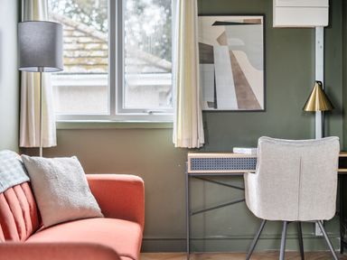 A living room with a sofa, desk and artwork at 1 Bedroom Apartment Sleeps 2 Pets Welcome in Carbis Bay