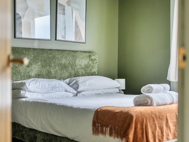 A bedroom with a bed and wall art at 1 Bedroom Apartment Sleeps 2 Pets Welcome, Carbis Bay